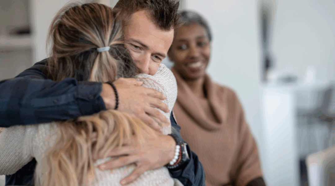 people hugging on therapy couch